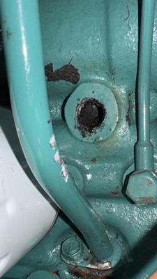 Drain tap removed from block, black sludge behind 